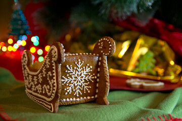 Gingerbread on a New Year's background. New Year's gingerbread with a bokeh light garland.