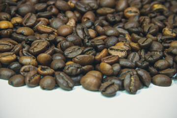 Background of roasted coffee beans close-up view from above.  Coffee beans close-up.