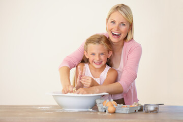 Having fun in the kitchen. Portrait of a mother and daughter having fun while baking together.