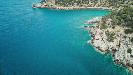 Obraz premium Aerial view of calm sea and rocky sea coast. Ocean coastline aerial view