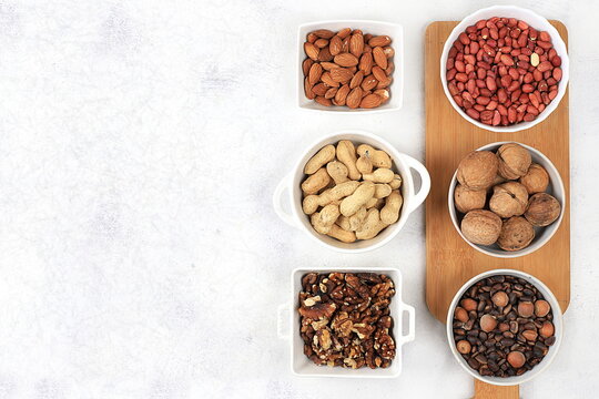 Assortment of various nuts, the concept of healthy natural nutrition, almonds, pecans, pistachios, cashews, walnuts and pine nuts, high-calorie food with vegetable protein and vitamins, 