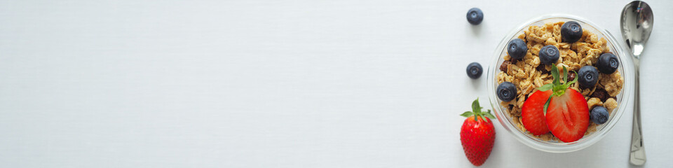 High Res Banner Healthy diet breakfast homemade granola muesli and fresh strawberries, blueberries on white background. The concept of health, beauty. Copy Space for information, top view, Flat Lay