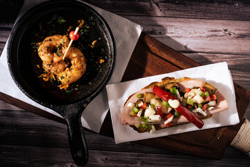 Two different and clasical Spanish tapas on a rustic table with a dark background. traditional spanish cuisine.