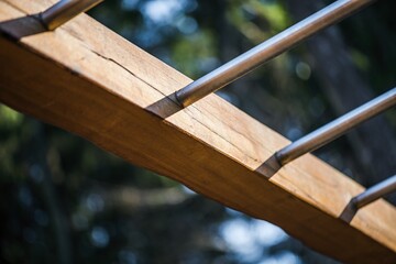 Ribs for strengthening the back and shoulders. City and forest gym, details of exercise aids made of stainless steel, rope and wood. Morning light for movement, exercise and energy.