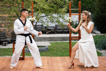 The groom in a karate kimono with the bride in a white dress. Mortal Kombat © Denys