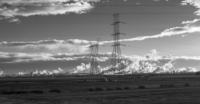 Black and white landscape photography, transmission lines and geothermal field, cloudy sunrise. Concept of Electricity industry geothermal electric power plants in Mexico. 