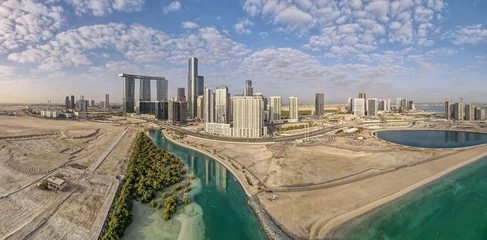 Fotobehang Aerial view on developing part of Al Reem island in Abu Dhabi on a cloudy day © Freelancer