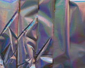high res full frame macro photo of abstract pastel iridescent holographic foil background with...