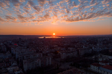 Cityscape from above. Sunset with dramatic clouds with drone