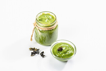 Jarred Kelp puree isolated on white background. Healthy superfood from oceanic seaweed