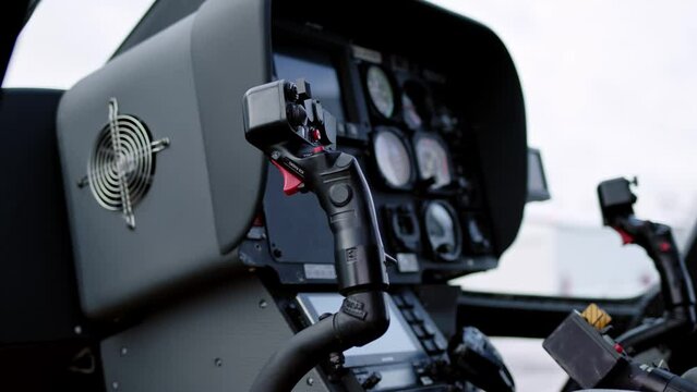 close up view of stick joystick of civilian business helicopter, cockpit is inside. Aircraft instrument panel, focus on helicopter control stick.