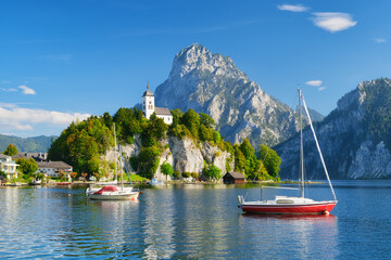 A yacht against the backdrop of mountains and an old castle in Switzerland. A popular place to...