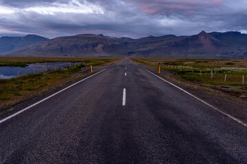 Beautiful aerial view of the great lonely highways crossing between mountains and nature, in Iceland 