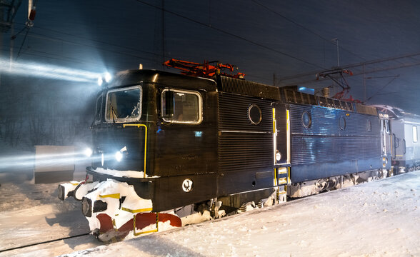 Passenger train at Abisko Ostra Railway Station in Swedish Lapland during snowstorm