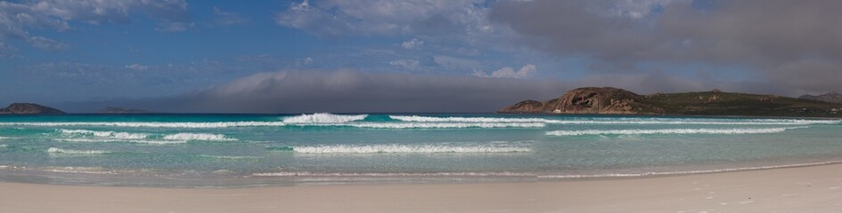 Panorama of sunny and idyllic white sand beach with no people and waves crashing in Esperance Bay,...