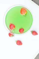 Colorful bright green cocktail cactus with strawberries, delicious refreshing