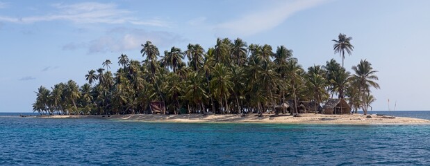 Panorama of sunny and idyllic San Blas Islands with palm trees and no people making a deserted island paradise between Colombia and Panama.