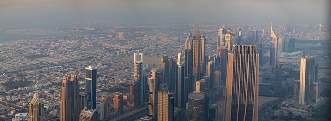 Fototapeta premium Panorama of buildings and fountains in the city of Dubai from the Burj Khalifa, the tallest building in the world in the United Arab Emirates.