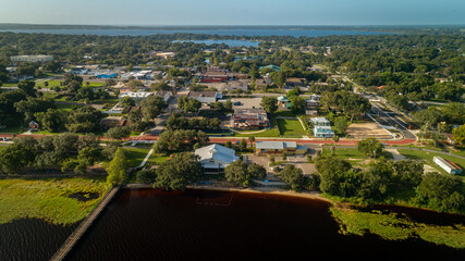 Drone shot over the bustling historic downtown Clermont on the waterfront edge of Lake Minneola.