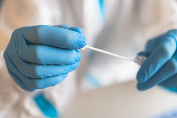 Process of coronavirus PCR antigen testing examination by nurse medic in laboratory lab, COVID-19 swab collection kit, test tube for taking OP NP patient specimen sample, patient receiving test