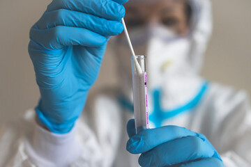 Process of coronavirus PCR antigen testing examination by nurse medic in laboratory lab, COVID-19 swab collection kit, test tube for taking OP NP patient specimen sample, patient receiving test
