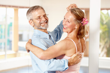 Theyve been dancing like this for years. Shot of a mature couple ballroom dancing together indoors. - obrazy, fototapety, plakaty