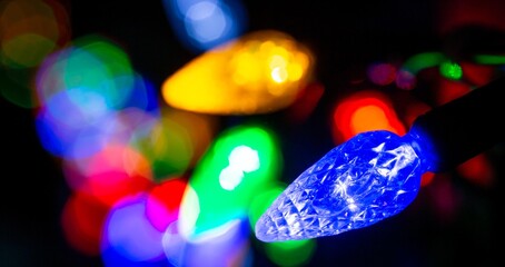 Multicolor Christmas lights along a fence