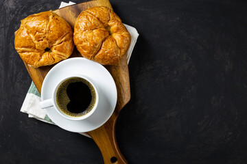 Breakfast / black coffee and croissants on the table /  flat top view with copy space for your text.