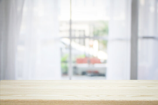blur wooden table in the kitchen on the window background in the morning..