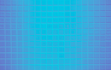 Neon glowing blank on blue tiled wall. Trendy classic color. Luminescent illuminated design wallpaper texture decoration. Modern seamless pattern empty for backdrop advertising banner poster or web.