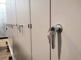 Close up photo of door handle with key on low voltage switchboard.