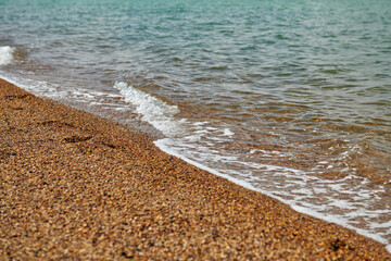 sandy beach with coarse sand and waves