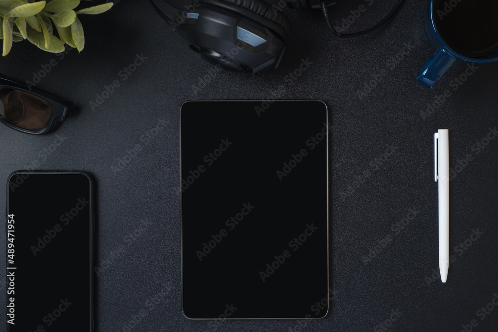 Poster top view working desk with keyboard headphone and tablet on black table background
