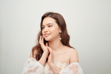 Beautiful portrait of asian young woman in white blouse on grey background.