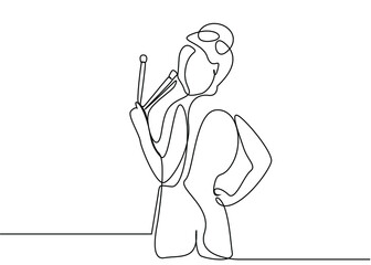 beautiful woman holding makeup brushes turns around and poses