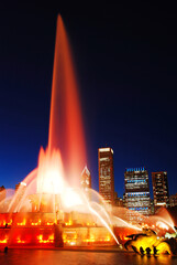 Flood let waters shoot up from the Buckingham Fountain at night and set against the Chicago skyline
