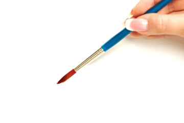 An artists delight. Close up shot of a female hand holding a paintbrush - white background.