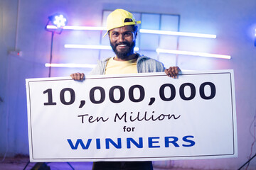 Enjyoing dancer showing winner price money presentation on stage by looking at camera - concept of...