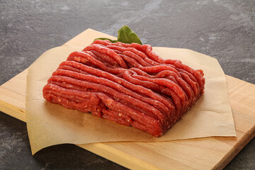 Raw beef minced meat over board