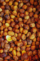 dried apricots with pits at the fruit market, selective focus