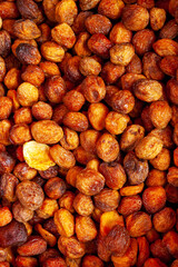 dried apricots with stones at the fruit market, close-up, selective focus
