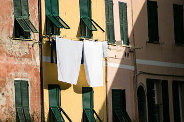 Colorful walls and green windows with the traditional way of hanging clothes from Palermo Italy