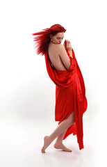 Full length portrait of red haired woman wearing a  beautiful sexy silk gown costume, standing pose...