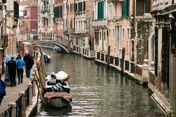 Fototapeta na wymiar Ancient and beautiful canals of Venice with pale colors and old bridges