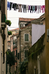 Fototapeta na wymiar Old streets of venice with traditional hanging clothes
