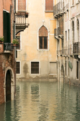 Ancient and beautiful canals of Venice with pale colors and old bridges