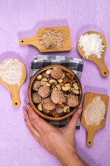 Various gluten free flour on table with nuts. Almonds, cashews, walnuts. Flat lay. Vertical photo