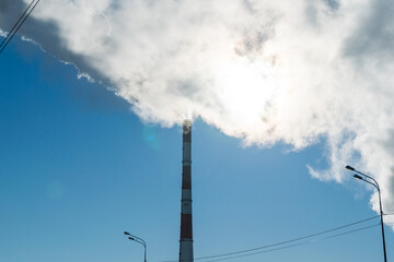 Obraz premium Smoke coming from the pipes of heat and energy plants over winter city. Air pollution