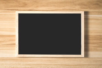 blackboard or chalkboard with frame on wooden background.