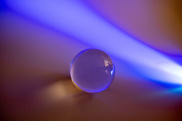 light purple light shining on a glass ball